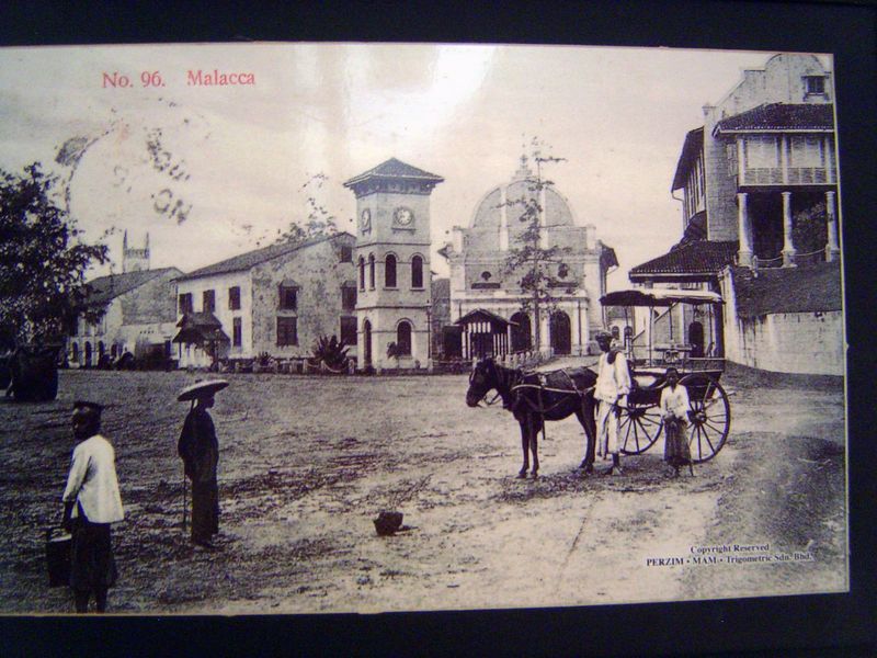 An old postcard, from the British period, shows a Victorian clocktower, Christ Church behind it, and the Stadthuys or Town Hall on the right
