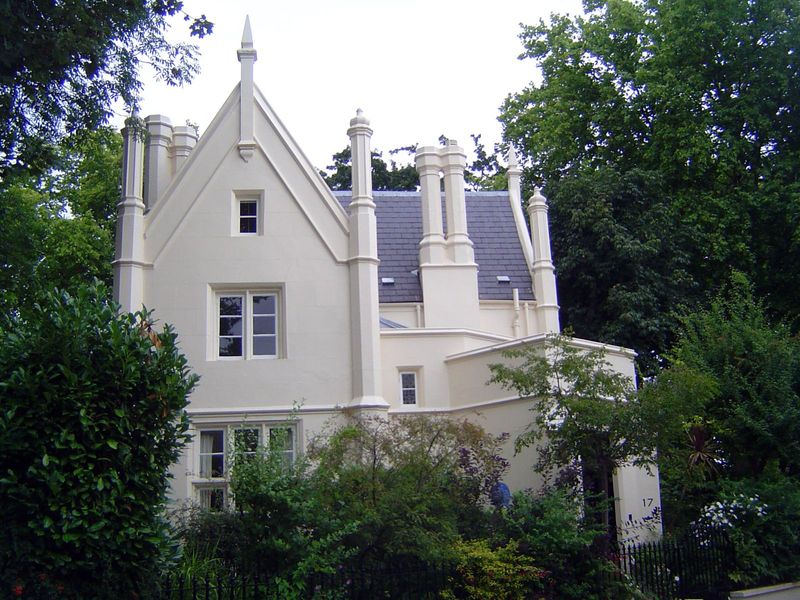 Another house in the same group is gabled and suitably shrouded in greenery, though the immaculate paint job cancels out what might otherwis