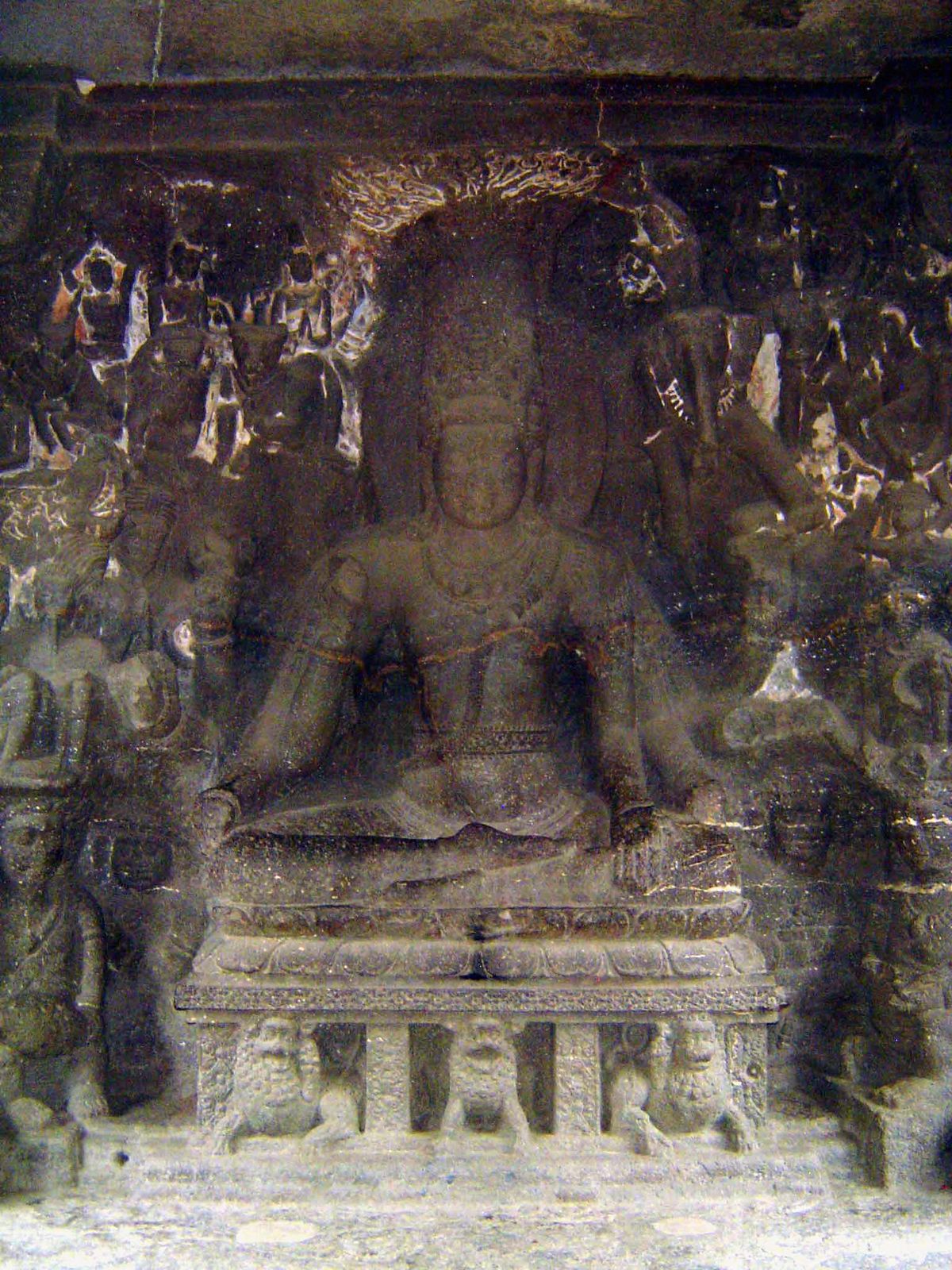 Mahayogi Shiva. The god sits on a lotus platform in meditation. To his side, sadhus meditate and musicians play but do not disturb Shiva.