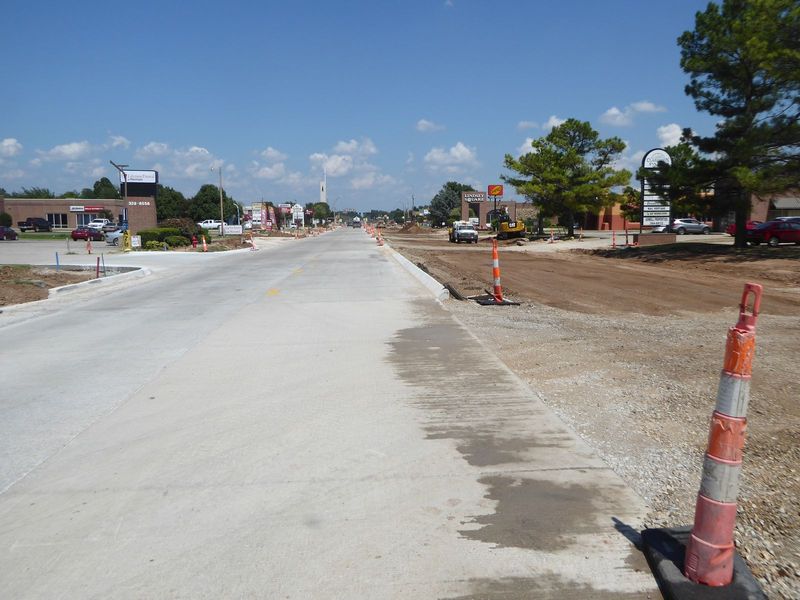 A new interchange means you have to pave the rest of the world, too. Here's Lindsey, with half of its new concrete poured. Two lanes will be
