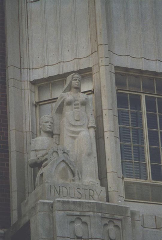 Adams Hall detail: Dame Industry, with Roboman well-behaved at her elbow. She wears a nun's habit but has the belly-plating of an space-warr