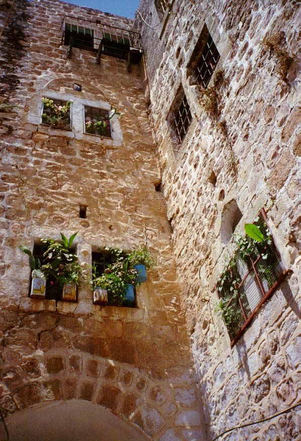 Big houses, massive masonry, arches, and green plants are characteristic of the old city.