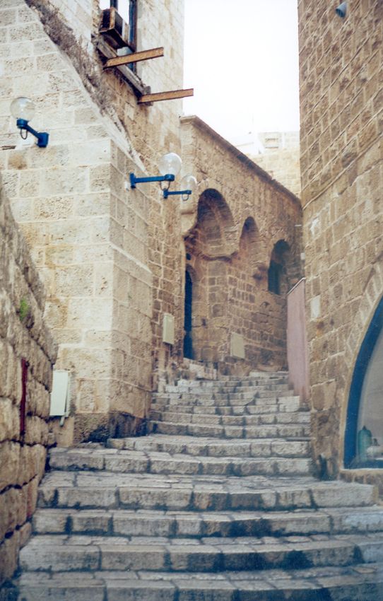 A stairway in the old city. The protruding I-beams are a relic of the British era, when they were introduced along with concrete. Economical
