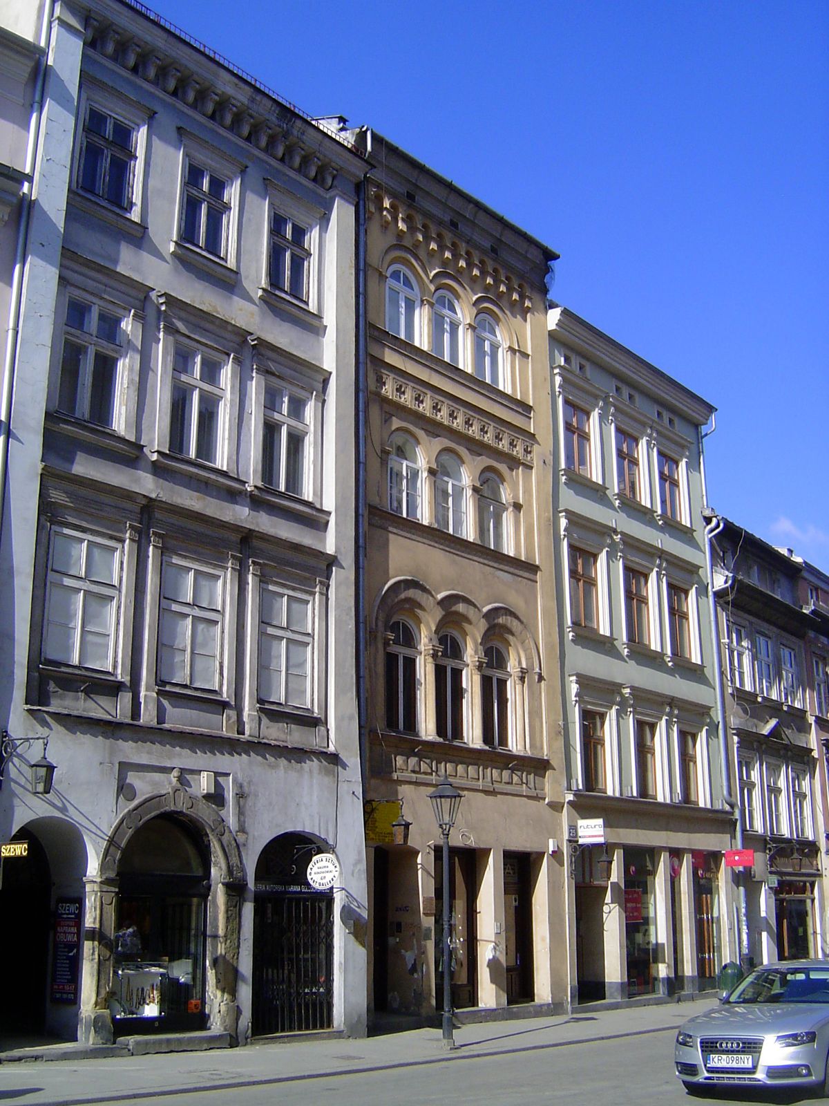 The street is lined with apartment buildings that have seen better days.