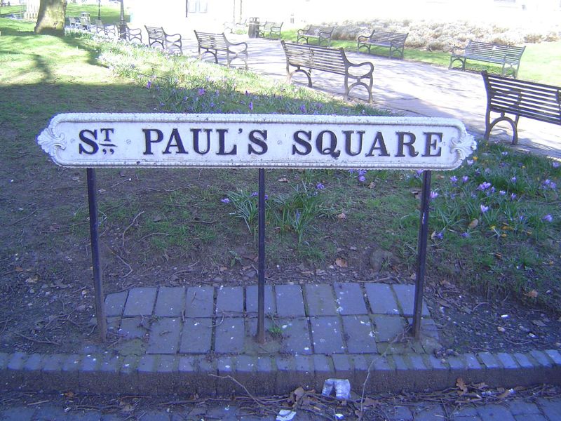 The square is said to be the city's only true Georgian square, neatly rimmed with three-story houses. The sign is of cast iron. It's heavy a
