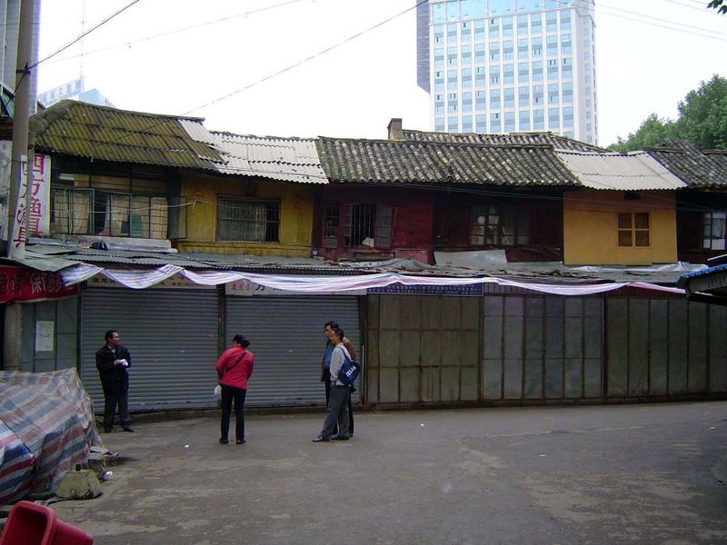 That market occupies a street whose margins are now lined with shops in front of the original shophouses.