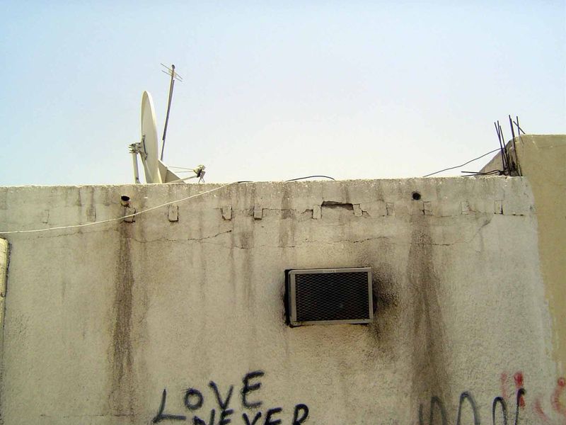 AC, satellite TV, no windows on the street, and a classic roof-construction technique, not so different from the vigas of New Mexico.