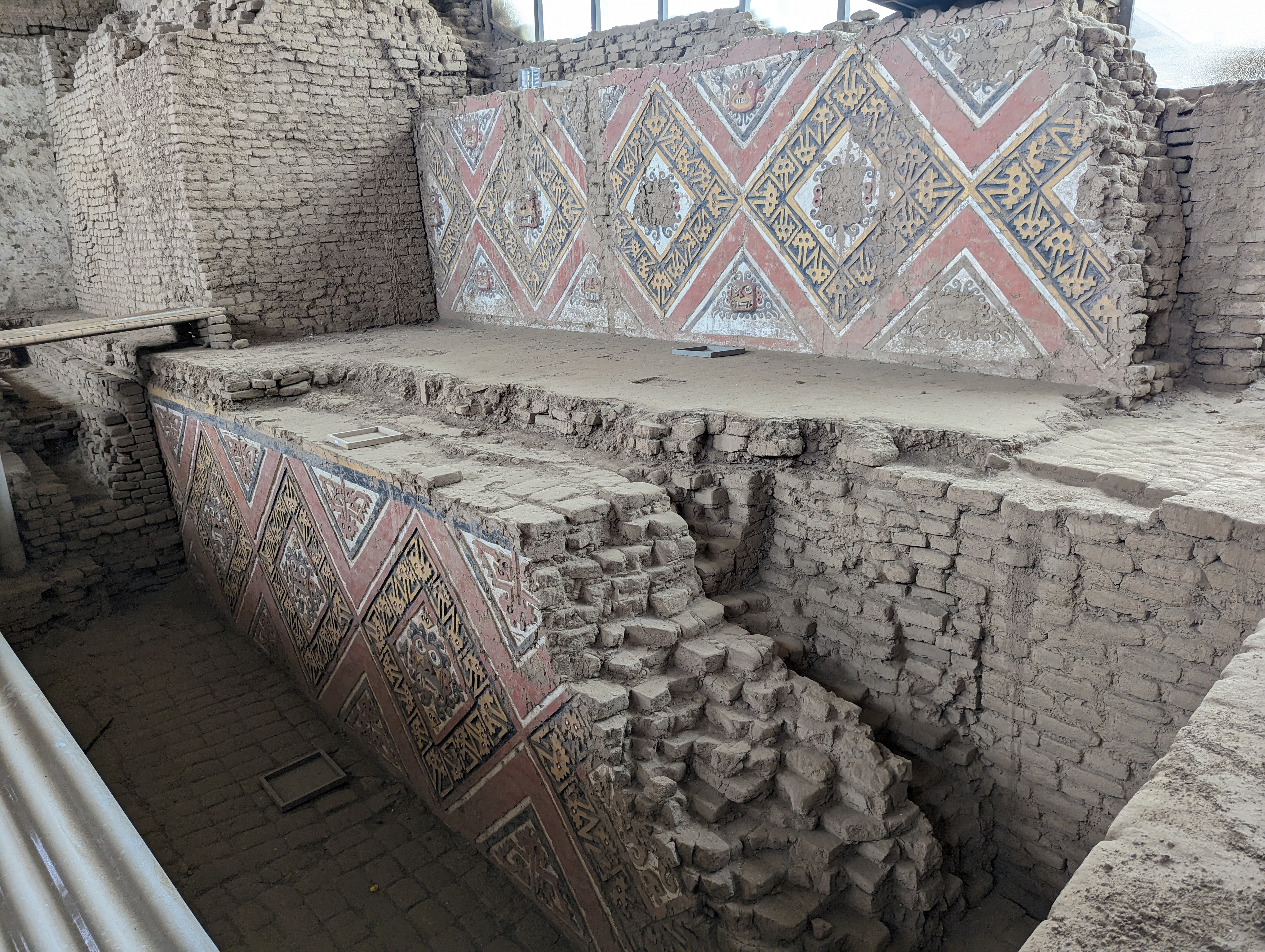 Higher up the pyramid, walls are covered with geometric figures at the center of which is an image of...  Guess!