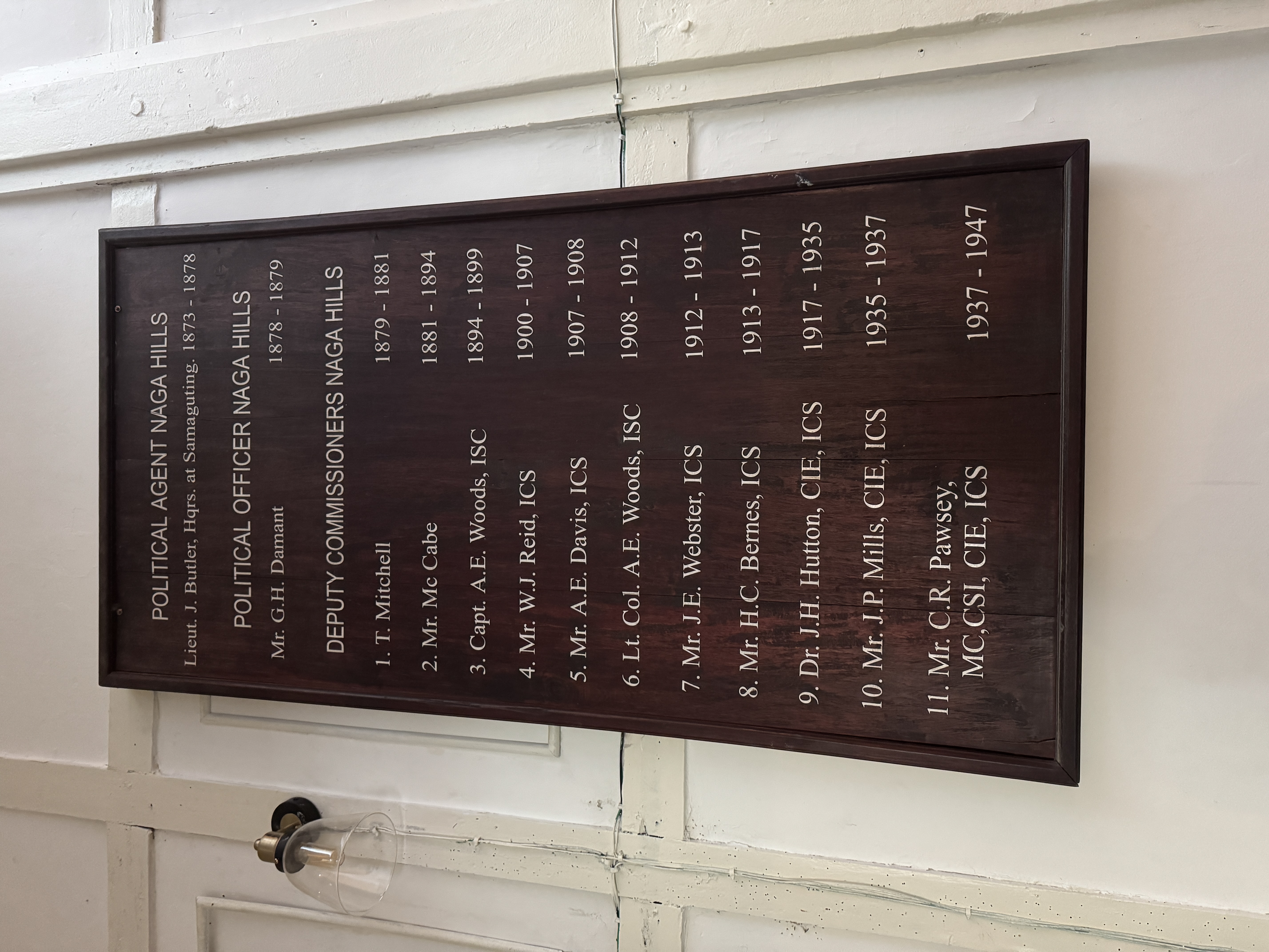 One wall has a list of the British officers in charge of the district.  It includes two men, John Henry Hutton and James Philip Mills, who w