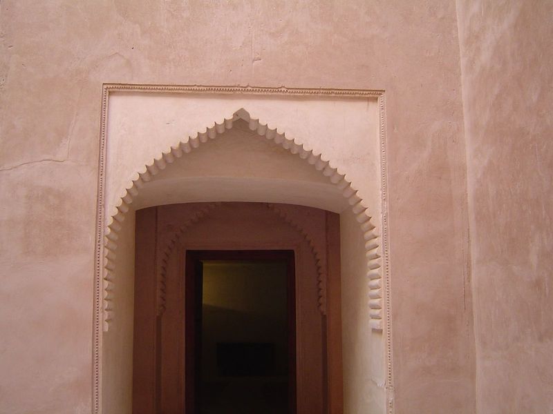 Finely scalloped ogee arch over an entrance from the courtyard.