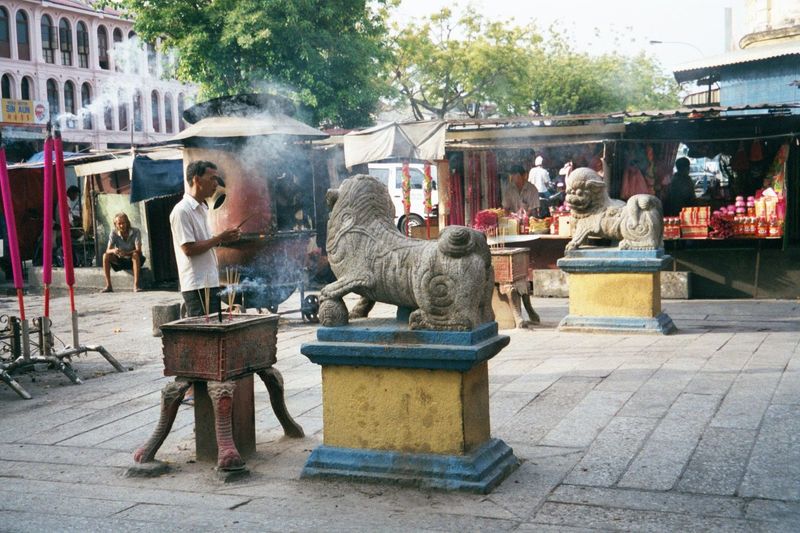 Outside, wishes and prayers are written on scraps of paper tossed into the cauldron, where they rise in smoke to the heavens.